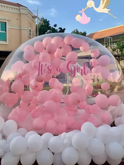It's a girl! The bubble house is filled with pink balloons, creating a stunning visual for the gender reveal announcement.