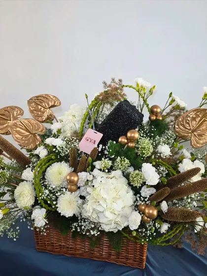 Marking a 50th birthday calls for something truly special. This sophisticated hamper combines pristine white hydrangeas with striking gold-painted anthuriums and other unique botanicals for a modern and celebratory arrangement.
