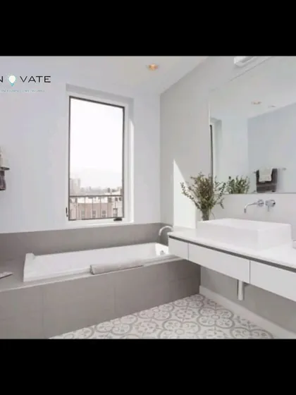 A clean and modern bathroom concept with a floating vanity and a large, simple bathtub, showcasing how we design for both style and function.