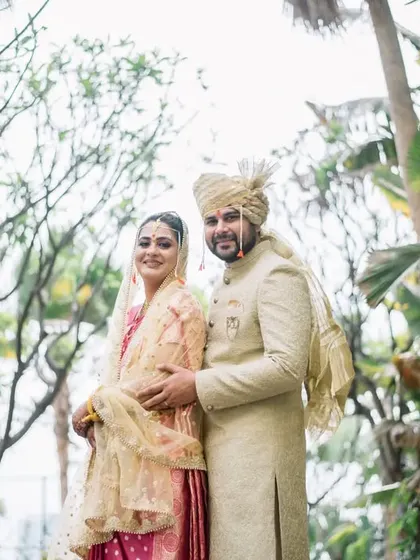 A wider shot of the couple in the lush green surroundings of the Hyatt. This photo showcases the beautiful venue and the happy couple.
