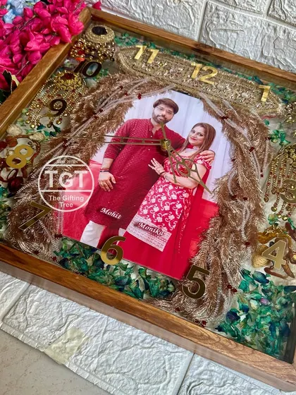 The sheer amount of detail in this 18-inch clock makes it a true centerpiece. The couple's photo is framed by the symbols of their union.