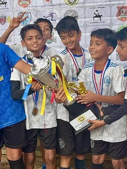 The U11s holding their trophy high. Reaching the semi-finals is a collective achievement for every child, parent, and coach at Bravo.