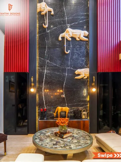 A detailed shot of the feature wall. The contrast between the black marble, the red fluted panel, and the white sculptures creates a stunning visual impact that immediately draws you in.