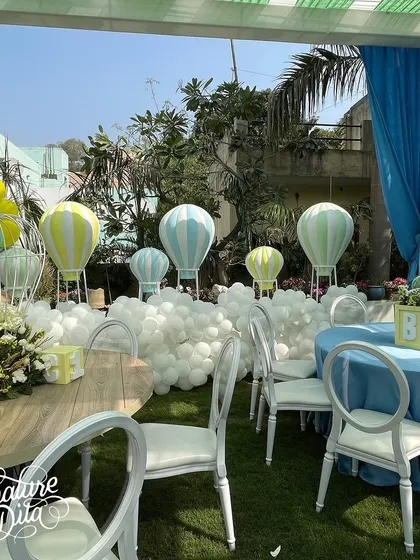 Another view of the baby shower decor, showing the arrangement of tables around the hot air balloon backdrop.