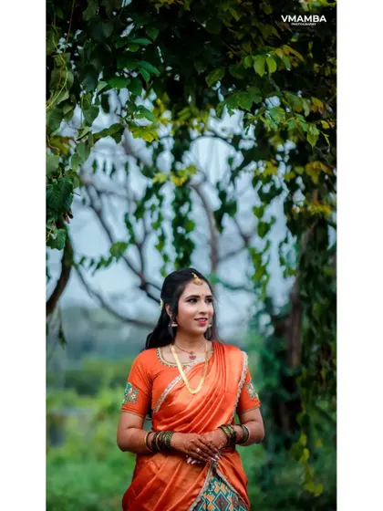 A beautiful outdoor portrait of a bride-to-be on her engagement day. The natural light and green foliage create a lovely, soft look.
