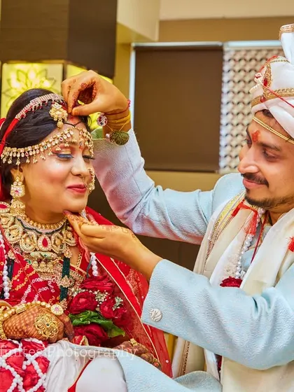 A candid photo of a caring gesture. These unposed moments often become the most treasured memories from the wedding day.