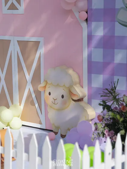 A sweet little sheep peeks out from behind the barn door. These custom-made character cutouts were placed throughout the venue to surprise and delight the young party guests.