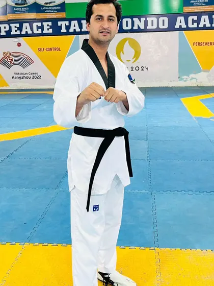 A portrait of Coach Amir Khan in the dojo. His presence and guidance are instrumental in shaping the next generation of champions at Peace Taekwondo Academy.