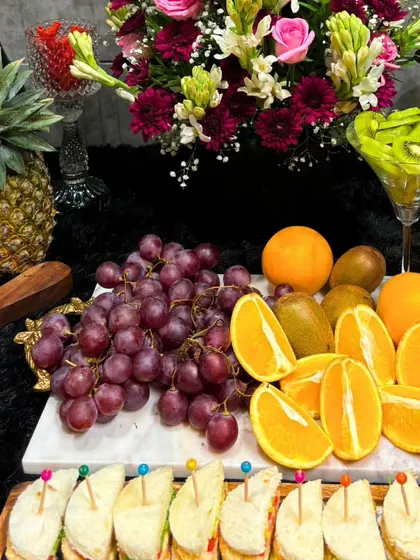 A close-up of the fresh fruit section of our grazing table, featuring grapes, oranges, and kiwis. We use only the freshest, highest-quality produce in all our displays.