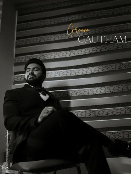 A classic black and white portrait of the groom, looking suave and confident. The dramatic lighting adds a touch of old-world charm and sophistication.