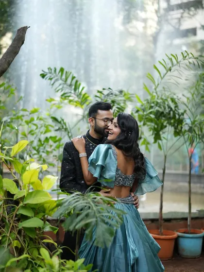 A candid, romantic moment between the couple. Her backless gown and the soft makeup create a look that is both elegant and modern.