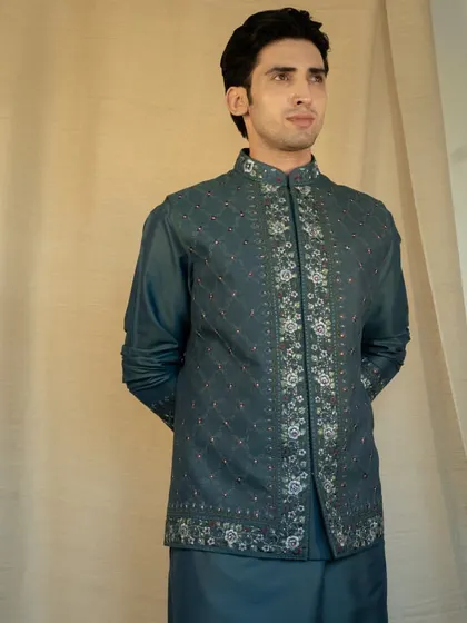 Step into elegance with our Reshmi Embroidered Teal Jacket set, uniquely crafted and customized to reflect your personal style.