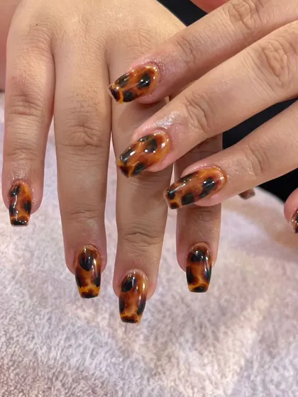 This is my take on the timeless tortoiseshell pattern. I create this classic, glossy design on coffin-shaped nail extensions, showing how a sophisticated print can elevate your everyday look.