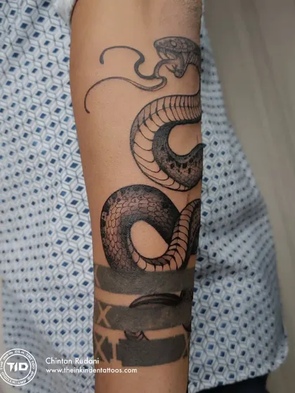 A side view of the snake tattoo, showing how it wraps.