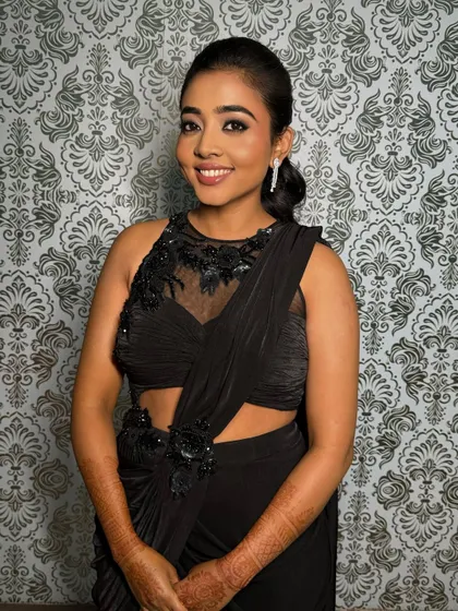 A happy and confident Deepa, ready for her sangeet night. The makeup is designed to be both glamorous and comfortable to wear.