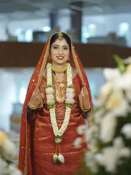 A beautiful shot of the bride walking through the venue. Her makeup and traditional attire create a stunning visual.