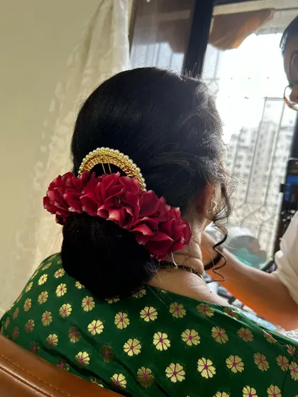 A close-up of the apple bun with a floral gajra. The neatness of the bun makes the flowers stand out.