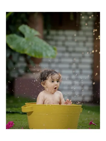 A look of surprise and delight as the water splashes up. These spontaneous reactions make for the best photos.