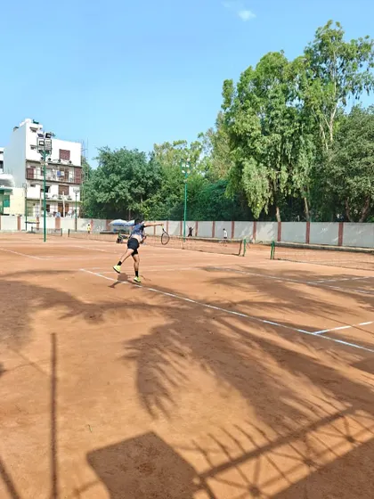 An action shot of a player mid-rally, showcasing dynamic movement and balance. Our drills are designed to simulate the physical demands of a real match.