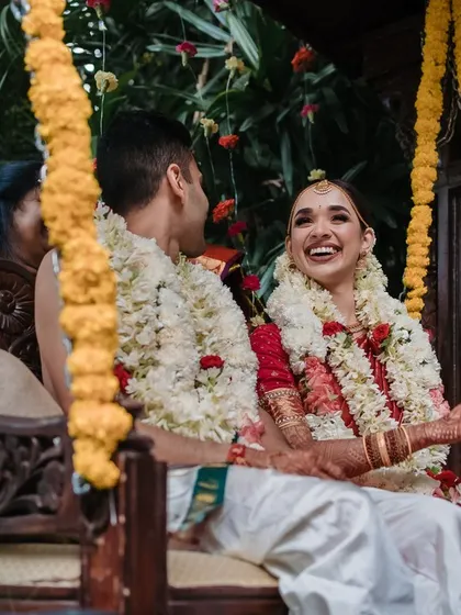 Laughter and love on a decorated swing during a traditional wedding ceremony. These simple setups create the most beautiful memories.