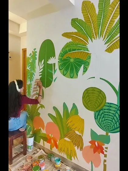 Getting into the zone while painting. This mural combines bold greens, yellows, and pinks for a truly energetic feel.