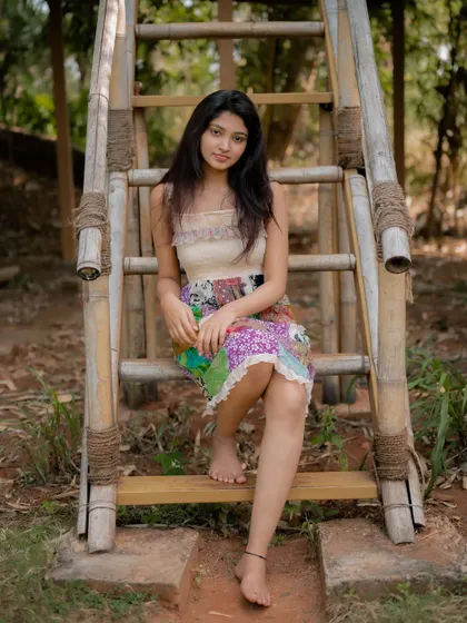 A duplicate of image 70, this candid and happy portrait of actress Rachana Inder on a bamboo ladder is full of joy and natural beauty.