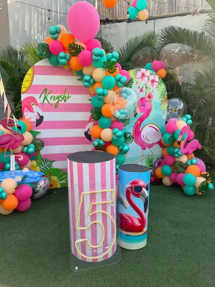 A flamingo-themed photo booth for a 5th birthday pool party. We love creating personalized and picture-perfect moments.