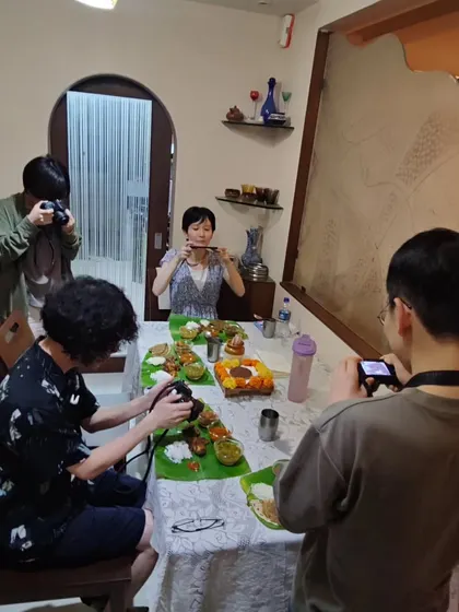 The moment of truth. Before we eat, everyone wants to capture the beautiful meal they've created. These travellers from Japan were excited to document every part of their Maharashtrian thali experience.