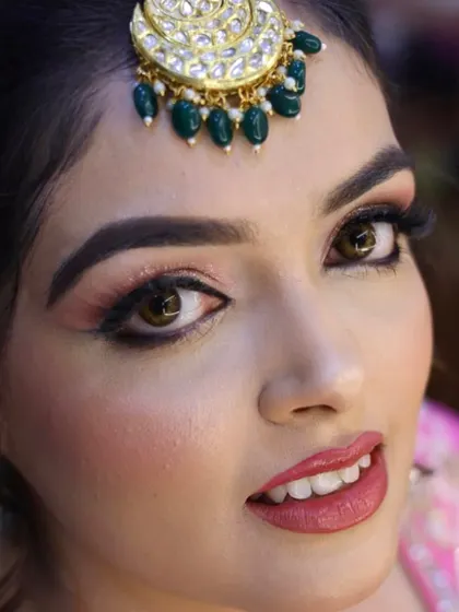 Real skin, real makeup. This close-up shows the detail of a soft, peachy-pink eyeshadow look with a clean winged liner, proving that you don't need filters for flawless results.
