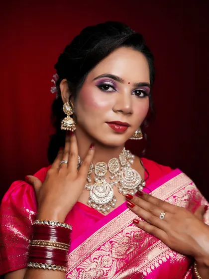 A close-up that focuses on the beautiful eye makeup and the intricate details of the traditional necklace.