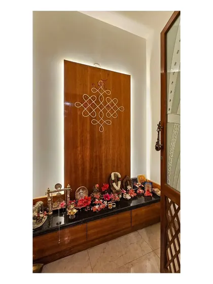 This traditional Kolam pattern was hand-painted on a wooden panel for a pooja room, offering a permanent and elegant alternative to daily rice flour drawings.