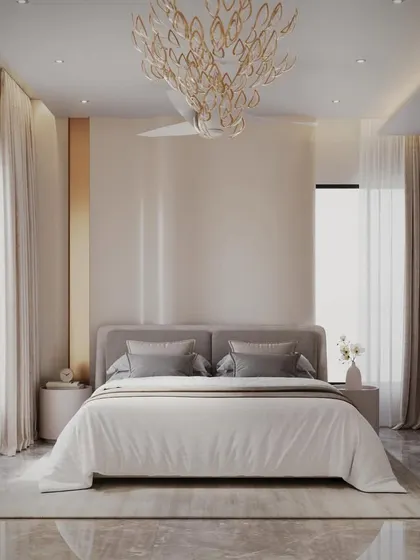 Pure elegance and tranquility. This bedroom uses a soft, neutral color palette, a stunning statement chandelier, and a curved, glossy wall panel to create a sophisticated and restful atmosphere.