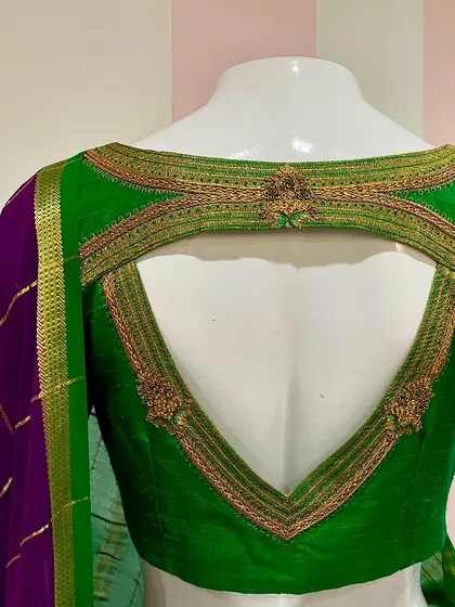 A closer view of the back of the green Mysore silk blouse, showing the detailed zardosi embroidery framing the cutout.