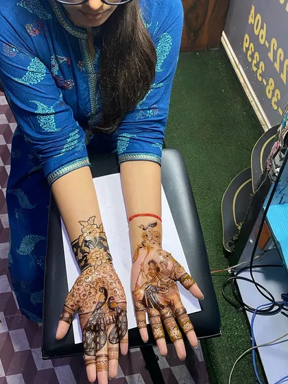 This client chose a beautiful design with peacocks and a portrait of Radha Krishna. It's a mix of traditional figures with a more open, modern layout.