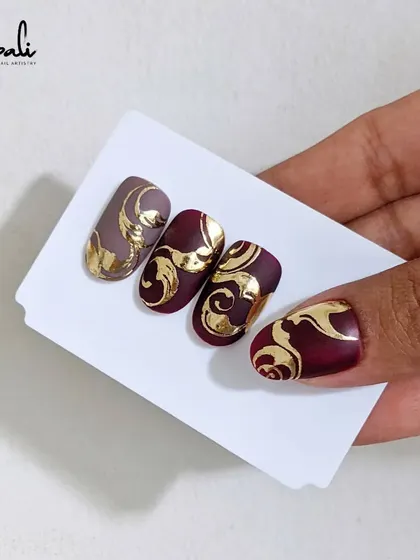 Holding the sample nails for the burgundy and gold foil design. This is one of the techniques I teach in my advanced courses.