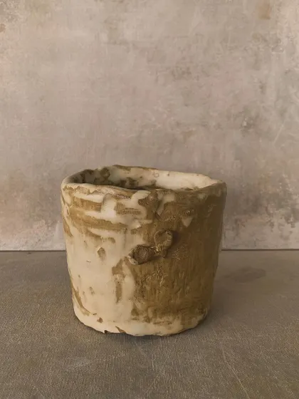 A rustic, textured pot with a creamy, dripping glaze. This piece has a wonderful, ancient feel to it.