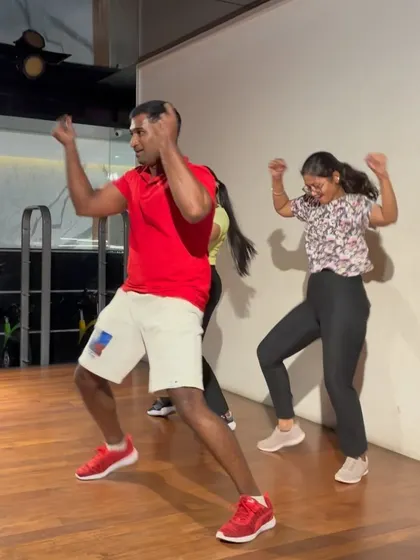 Teaching a move to participants during the high-energy dance session.