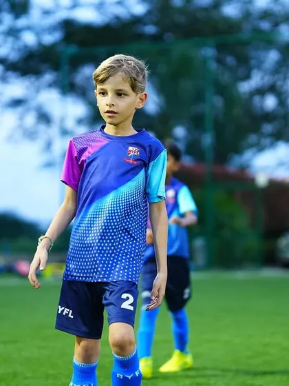 A young player stands focused and ready for the next drill. Discipline and concentration are key skills we teach.