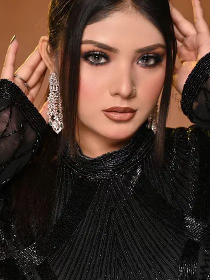 This close-up shows the intensity of the eye makeup and the beautifully defined nude lip, a classic combination for a glamorous look.