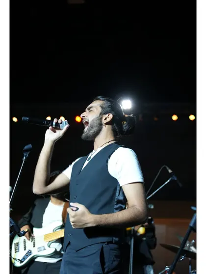 A close-up of our vocalist Aryaman, passionate and in his element during a performance for a corporate client.