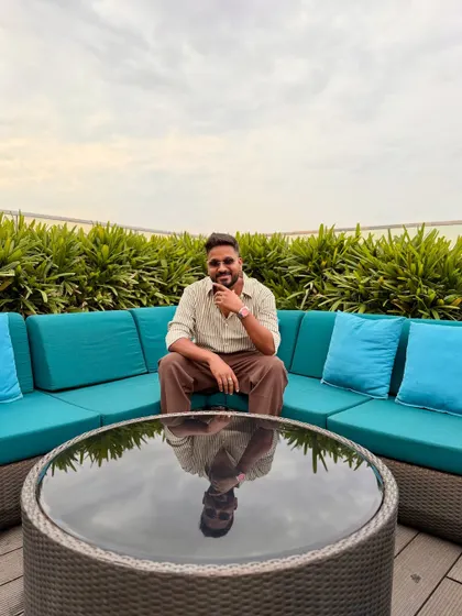 A smiling shot with my reflection in the table.