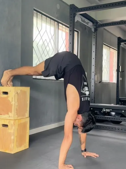 A pike push-up with feet elevated on boxes. This is a great progression towards a full handstand push-up.
