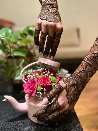 Another angle showcasing the beautiful flow of this engagement henna design. Notice the intricate cuff work around the wrist, which connects the palm design to the forearm pattern seamlessly.