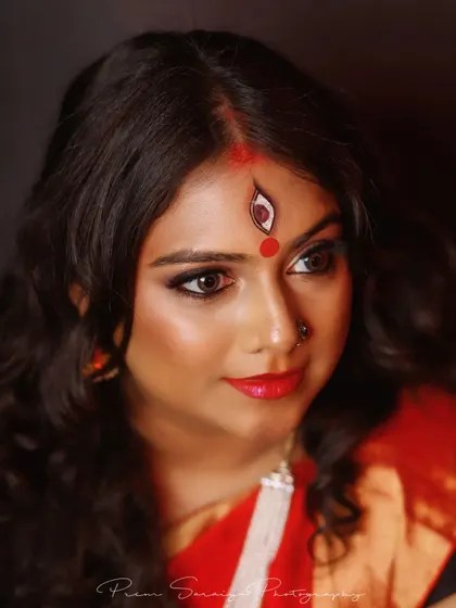 I love getting creative for themed photoshoots. For this Navratri-inspired Devi look, we focused on powerful, expressive eyes and artistic details like the hand-painted third eye, creating a truly memorable and divine portrait.