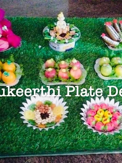 An engagement platter arrangement at RVS Mahal, Sulur. The display includes beautifully arranged sweets, dry fruits, and a couple doll.