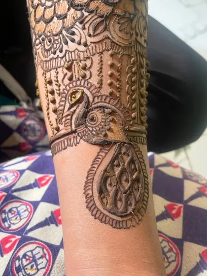 Another look at the detailed peacock design. The fine lines and shading bring the bird to life.