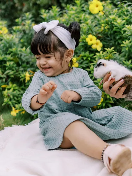 The pure joy of a little girl meeting a guinea pig at a farm. These sessions are perfect for animal-loving kids.