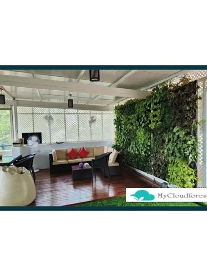 A large vertical garden serves as the stunning backdrop for this spacious covered terrace. The living wall adds a massive burst of green and improves air quality, making the seating area feel like a secluded jungle hideaway.