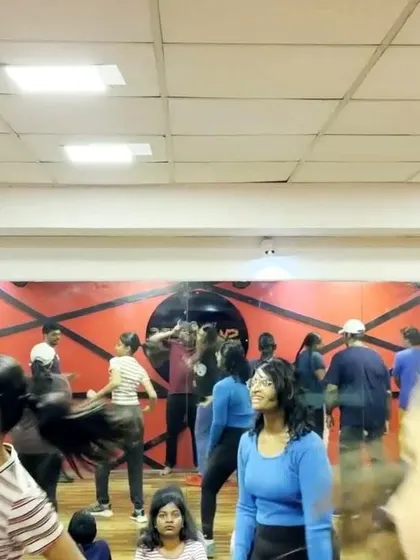 A candid moment during a busy rehearsal. Even while taking a break, the energy and excitement for the upcoming show are clear.