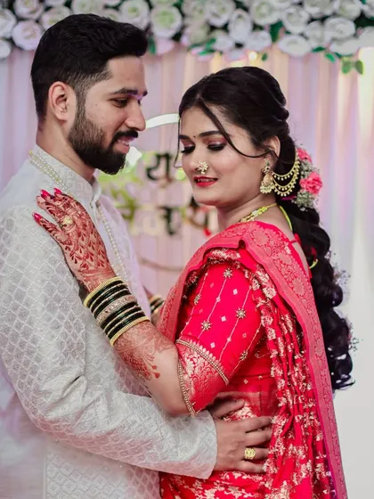 An intimate portrait of an engaged couple, capturing a moment of quiet connection against a decorated backdrop.